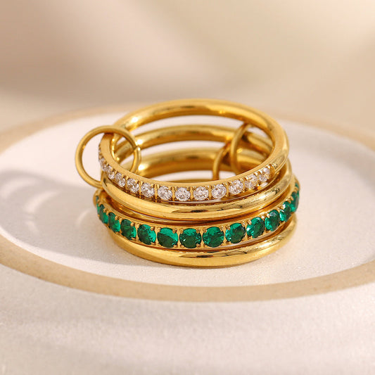 gold ring with gemstones on a beige background