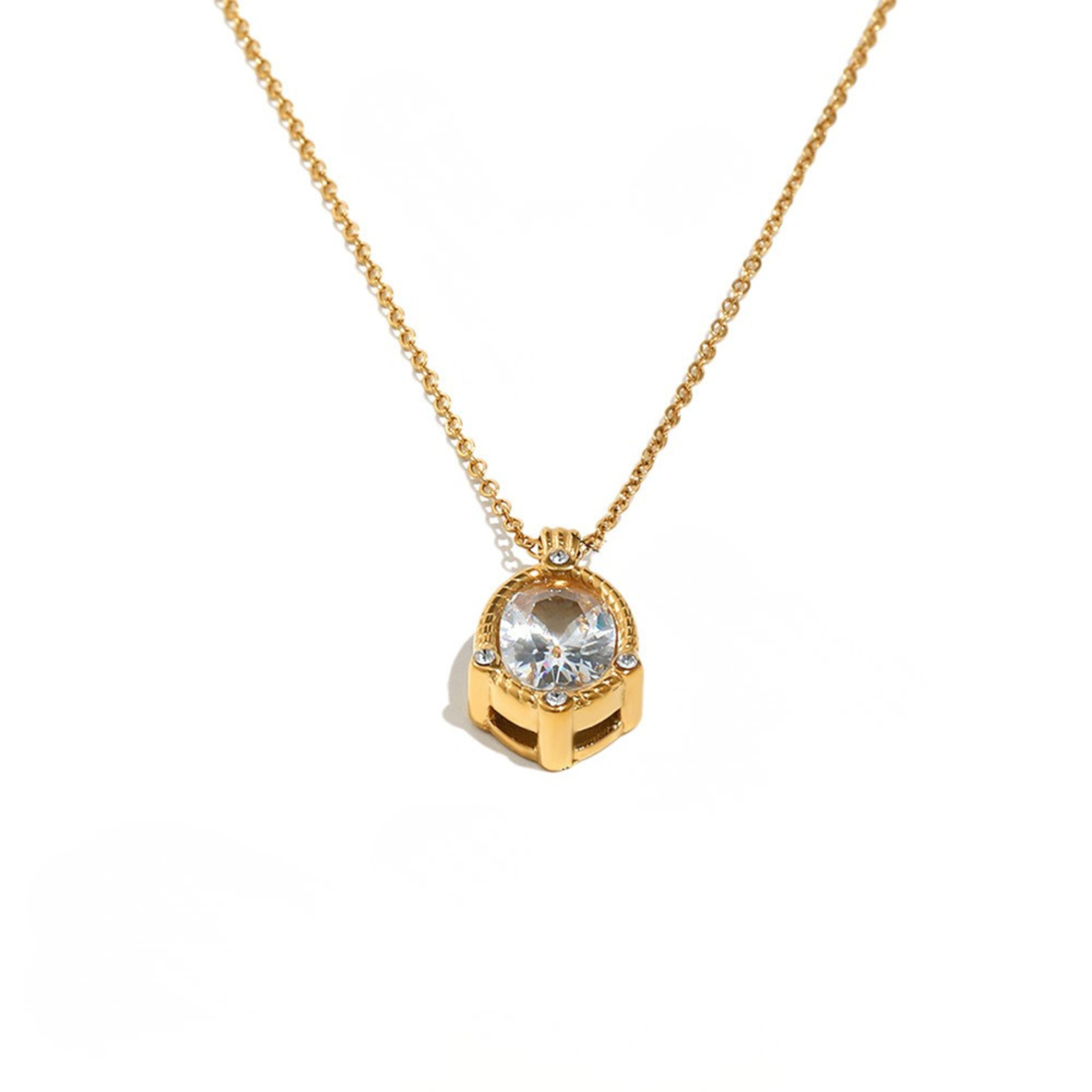 A gold chain necklace with a geometric pendant featuring a large clear round-cut gemstone and small accent stones, shown on a plain white background.