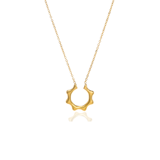 A gold necklace featuring a textured, wavy circular pendant on a delicate gold chain, presented against a clean white background with a soft reflection below.