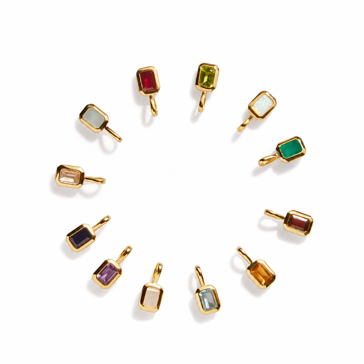 Twelve small gold Birthstone charms with different colored stones, arranged in a circular pattern on a white background.