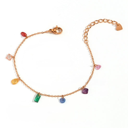 A delicate gold chain bracelet featuring multiple small, colorful gemstone charms in various shapes, displayed on a clean white background.