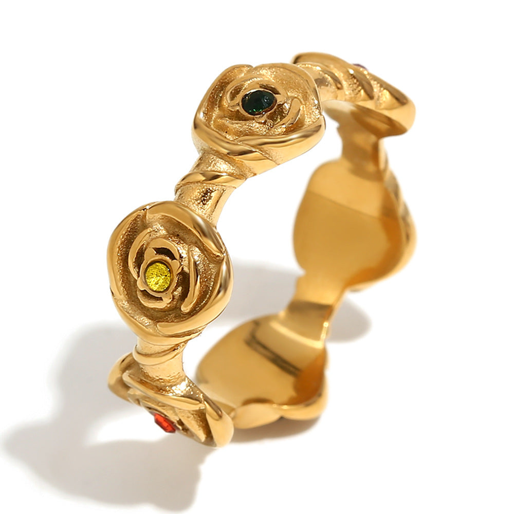 Gold ring with rose designs on a white background