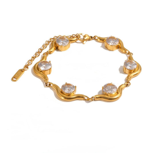 A gold chain bracelet with five bezel-set round clear stones, displayed on a clean white background.