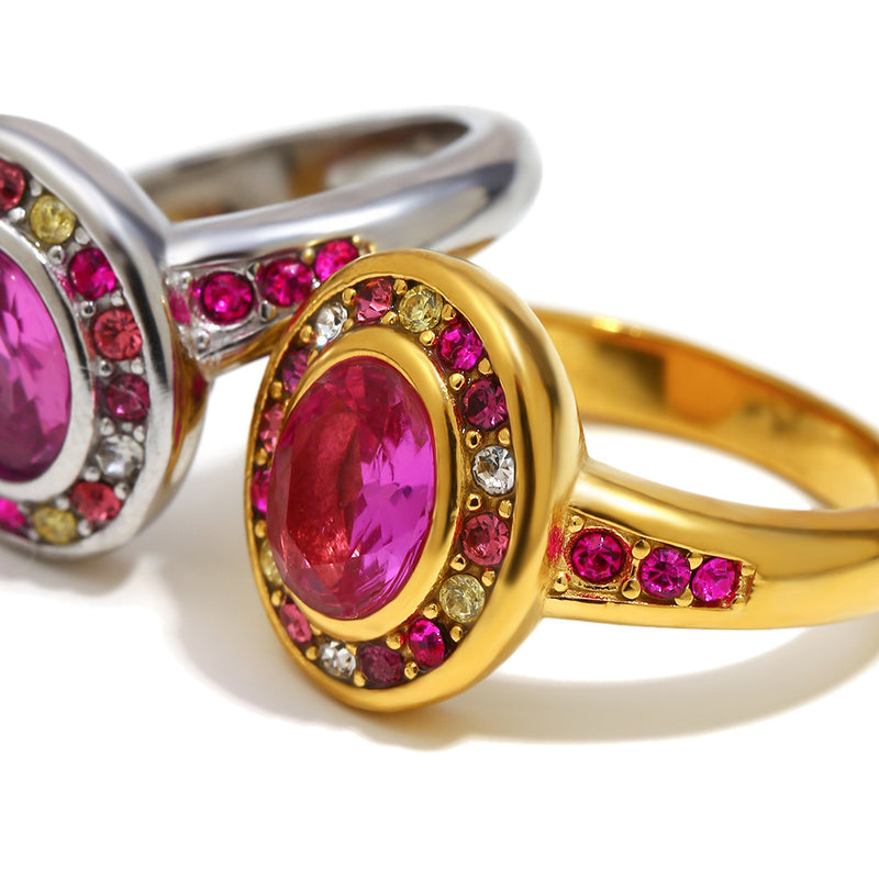 Two rings with pink gemstones and colorful stones on a white background