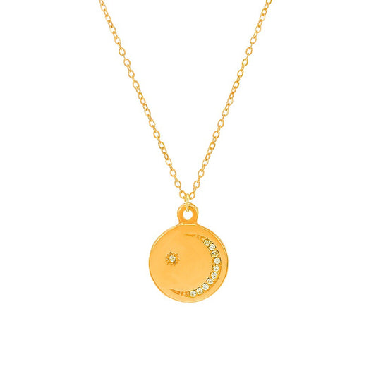 Gold necklace with a round pendant on a white background