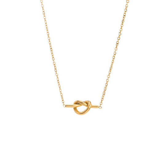 A delicate gold chain necklace featuring a central knot pendant suspended on a horizontal bar, presented on a clean white background.