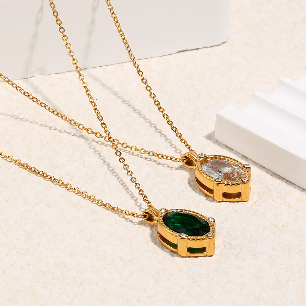 Two gold necklaces with gemstones on a light background