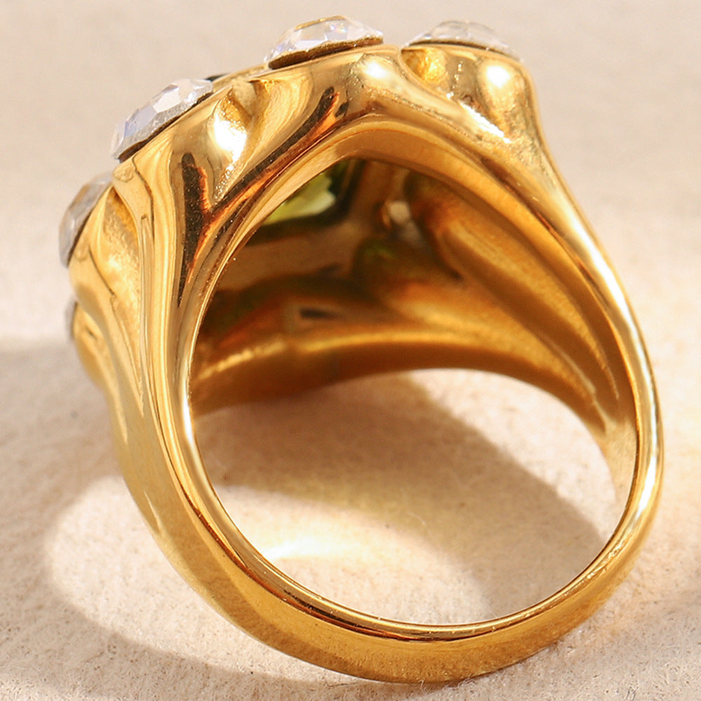 Gold ring with a textured band on a beige background