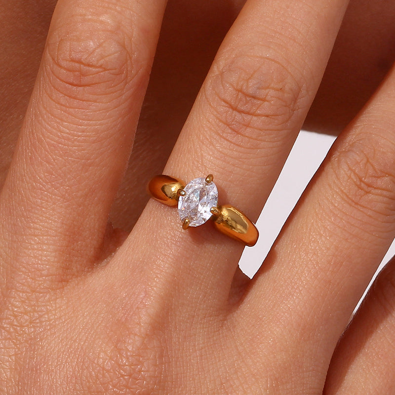 Gold ring with a diamond on a person's finger