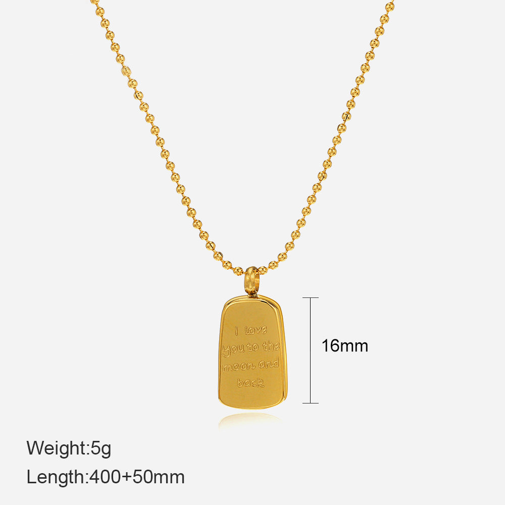Gold necklace with a rectangular pendant on a white background