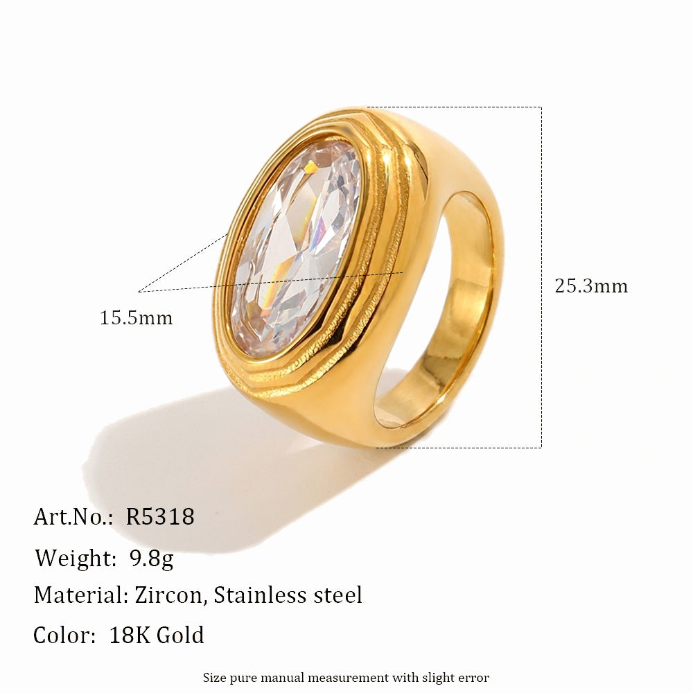 Gold signet-style ring with a large oval clear crystal, shown on a white background with measurement annotations (15.5mm width, 25.