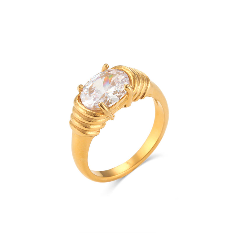 Gold ring with a clear gemstone on a white background