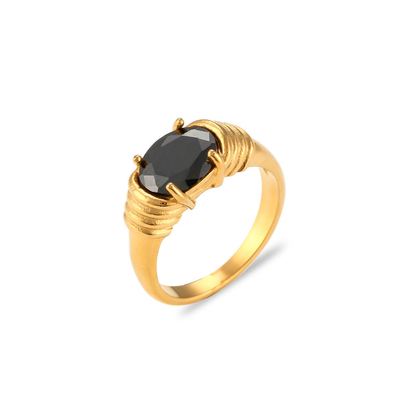 Gold ring with a black gemstone on a white background
