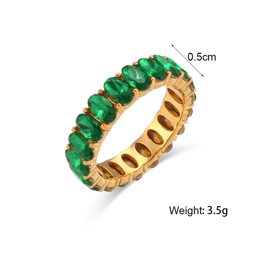 A gold eternity ring with oval green emerald-cut stones, shown on a white background with a dimension marker of 0.5cm and a weight label of 3.