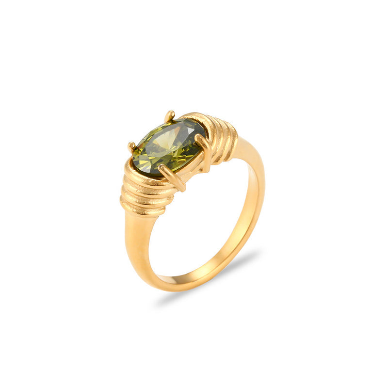 Gold ring with a green gemstone on a white background