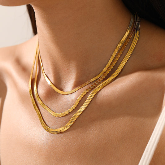 Gold necklaces on a person's neck