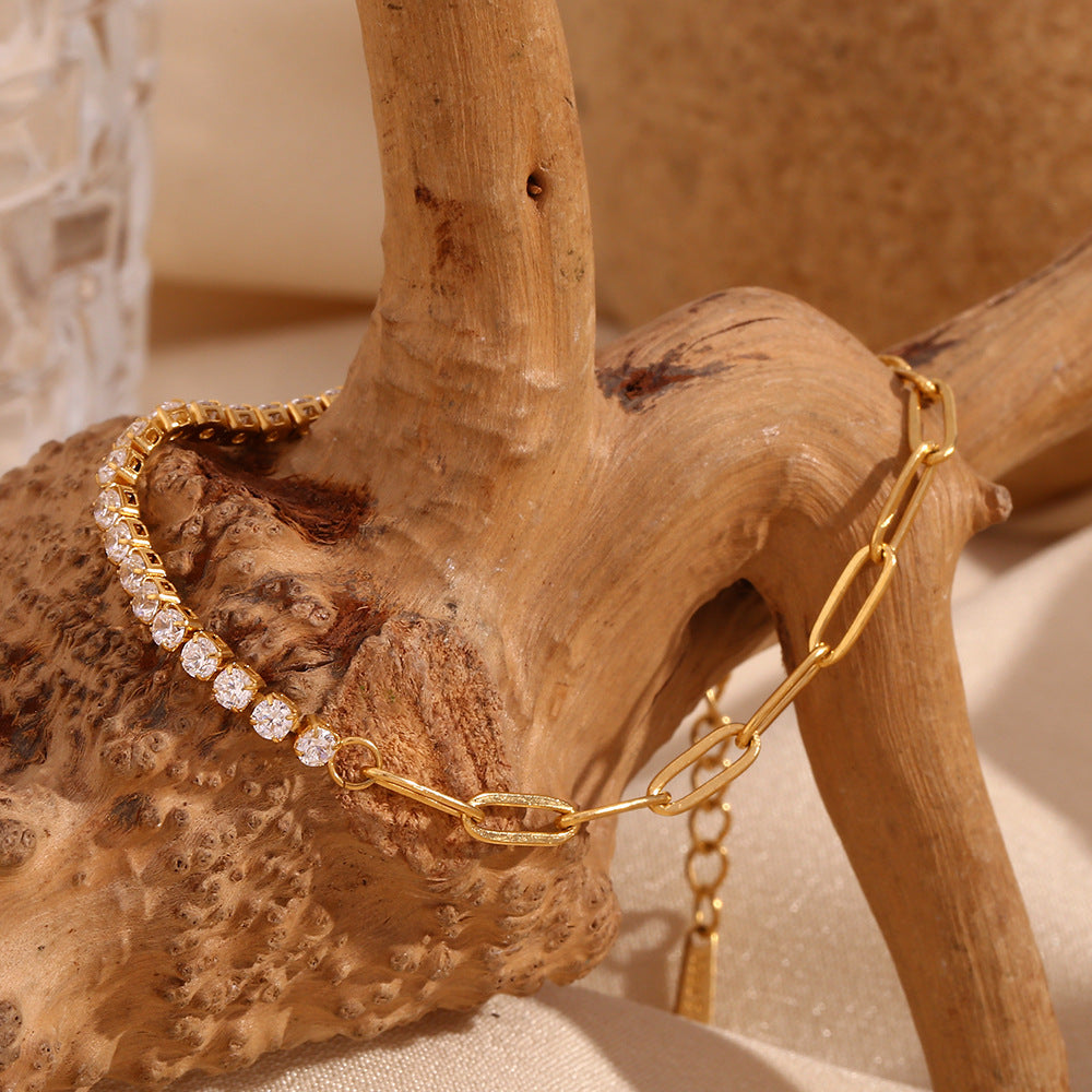 Gold bracelet with clear stones on a wooden branch