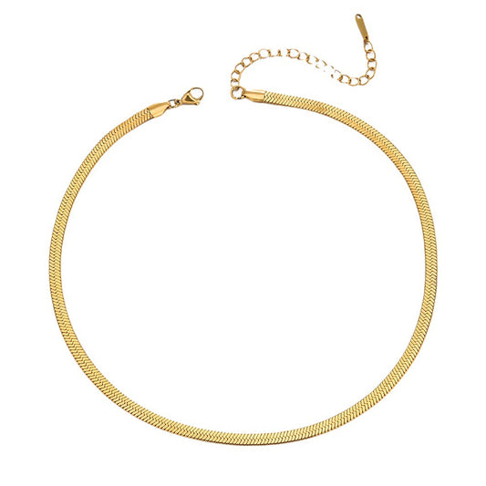 Gold snake chain necklace on a white background