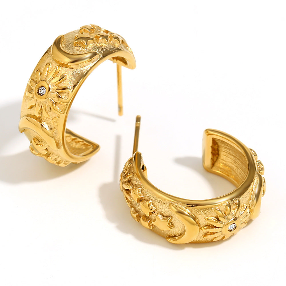 Celestial Star, Moon & Sun Hoop Earrings with intricate designs on a white background