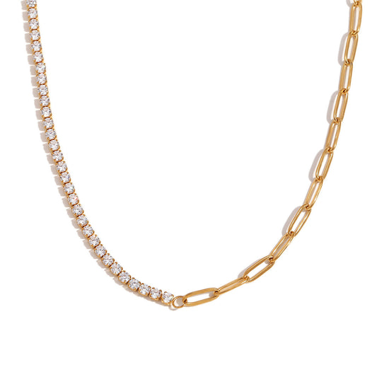 Gold chain necklace with diamond-like stones on a white background