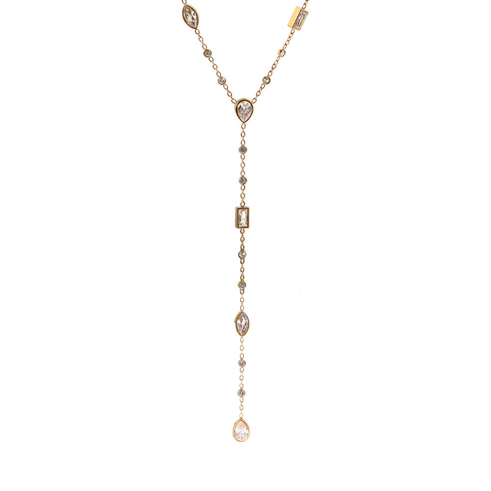 A delicate gold Y-necklace featuring multiple clear gemstones of various shapes including teardrops, marquise, and rectangular, displayed on a solid white background.