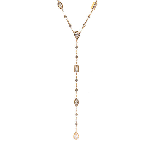 A delicate gold Y-necklace featuring multiple clear gemstones of various shapes including teardrops, marquise, and rectangular, displayed on a solid white background.