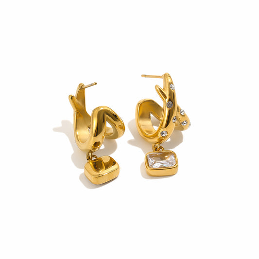 A pair of gold-toned hoop earrings with dangling rectangular clear gemstone charms and small rhinestone accents, photographed on a clean white background.