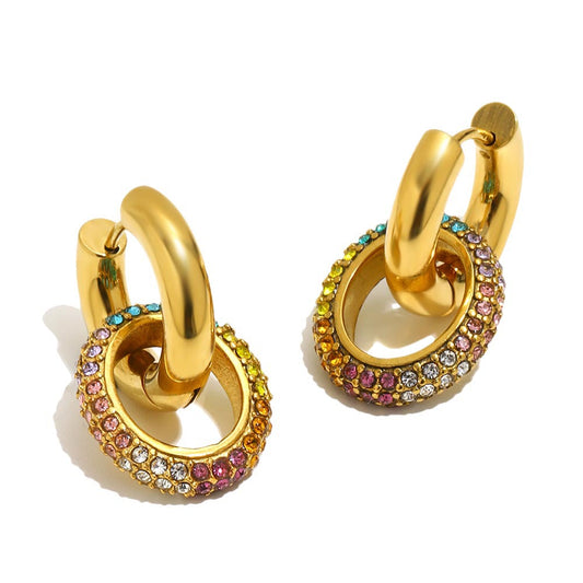 A pair of gold huggie hoop earrings with multi-colored gemstone pavé borders, shown on a clean white background.